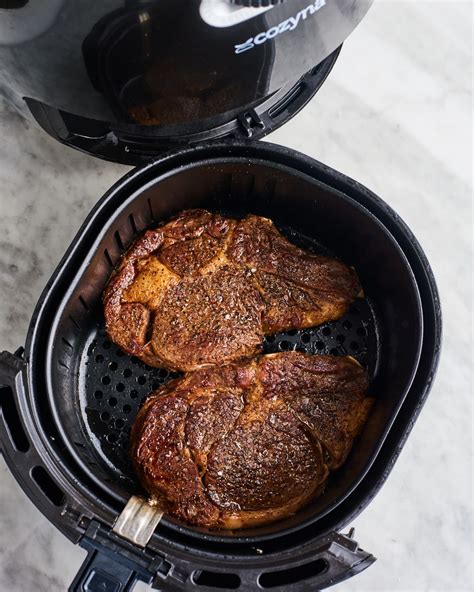 rub the steaks with the olive oil, salt and pepper on both sides. . Broil steak air fryer
